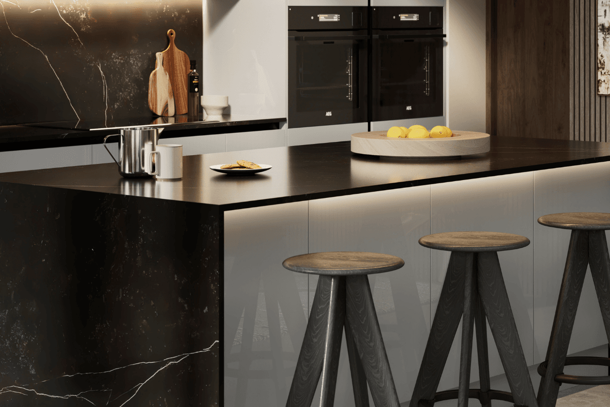 Kitchen with black worktop and solid splashback with white veining