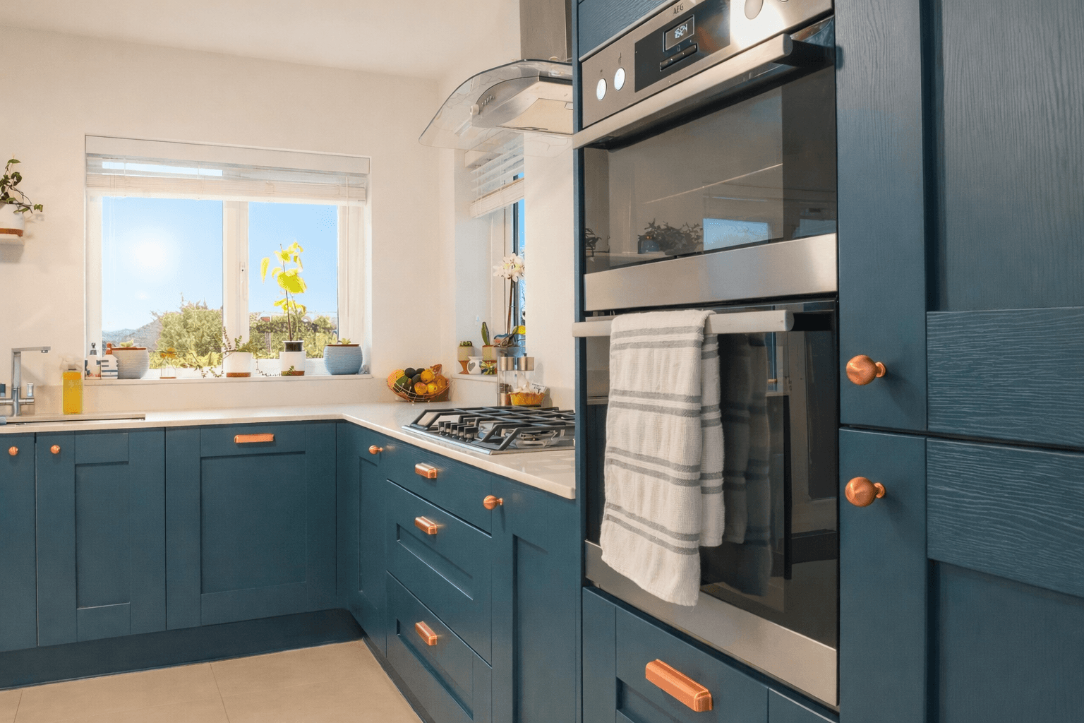 Shaker kitchen with blue doors and copper cup and knob handles