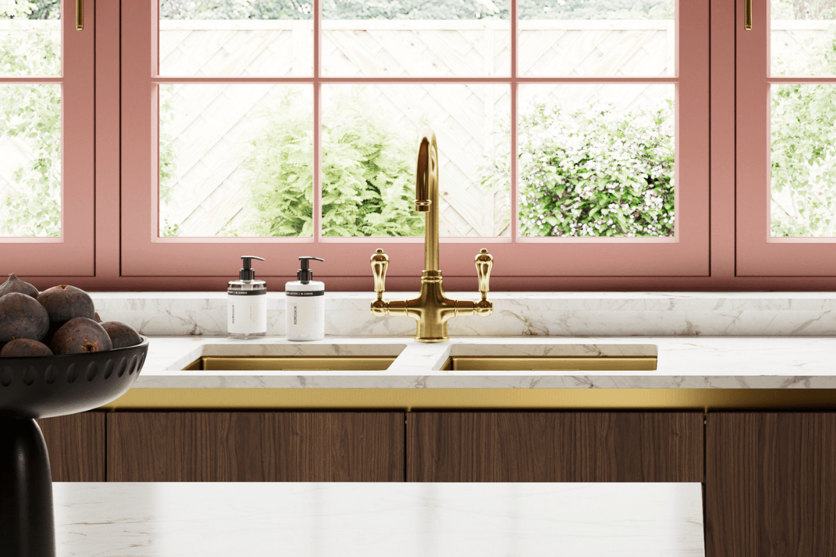 Kitchen with white marble effect worktop, and gold sink and tap